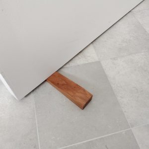 Recycled Rimu Door Stop being used